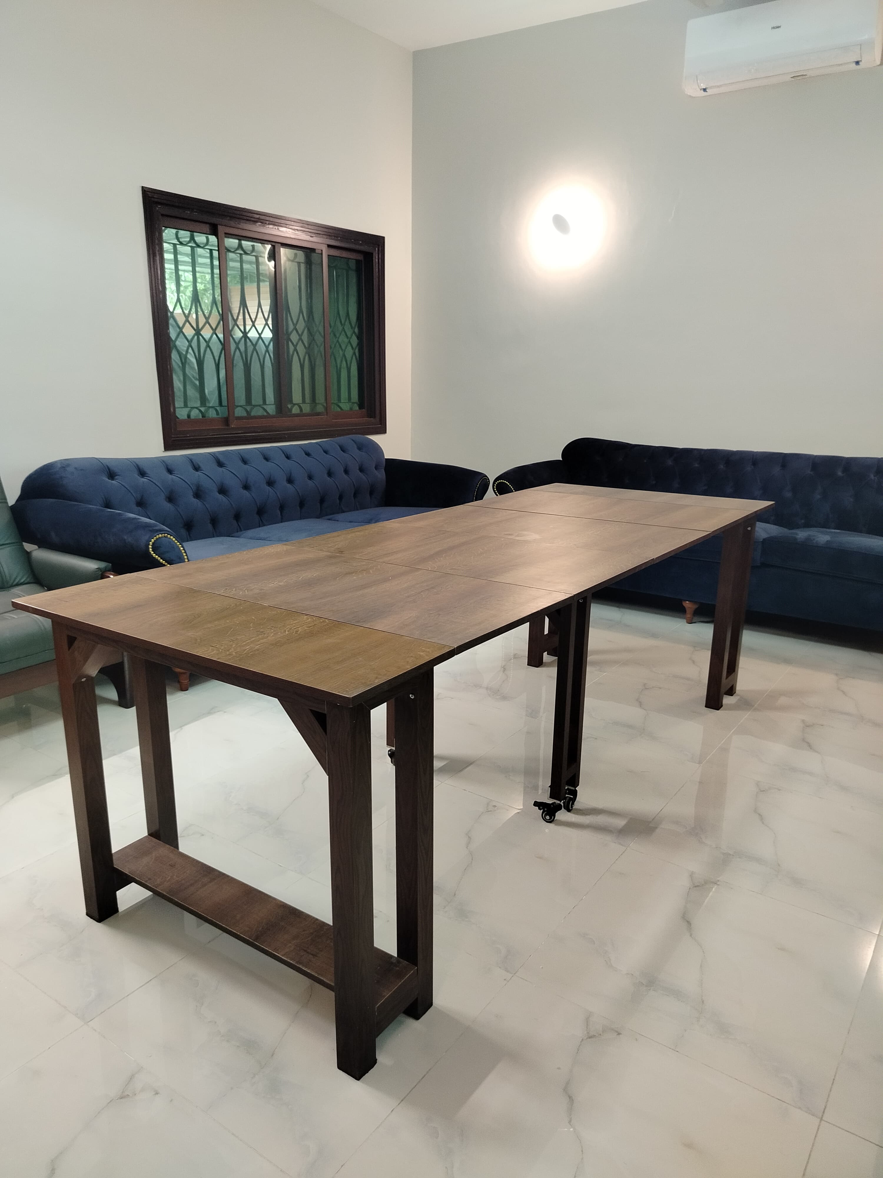 Extendable dining table with aluminum legs and MDF top, adjustable from 36 inches to 8 feet.