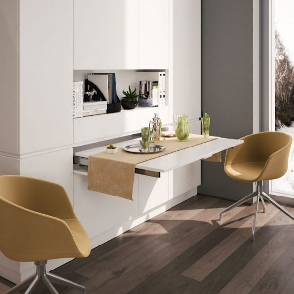 Pull-out peninsula table extending from a drawer compartment.