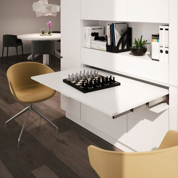 Pull-out peninsula table extending from a drawer compartment.