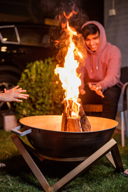 Antique brass fire bowl with a 25-inch diameter, featuring a heat-resistant coating, durable metal construction, and a stable bottom stand. Ideal for outdoor gatherings, this fire bowl combines elegance with functionality