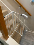 baby gate blocking a staircase to prevent access