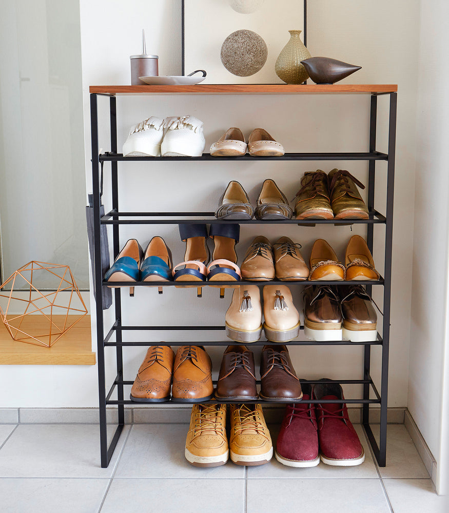 Six-tier shoe rack (34" H) in black, featuring a tall, slim-profile design with space for taller shoes and boots, clip hooks for hanging accessories, and dimensions L 9.84 x W 25.98 x H 34.25 inches, ideal for organized footwear storage