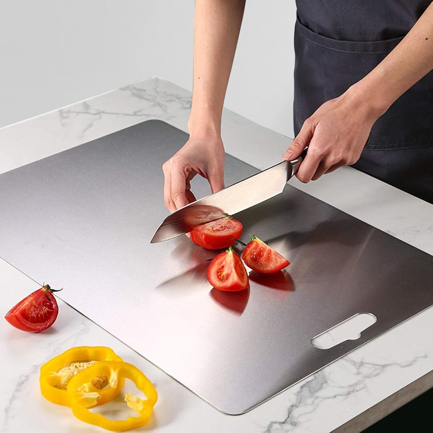 Stainless steel chopping board (33cm x 22cm), made from 100% food-grade, eco-friendly material. Features rounded edges and anti-skid pads for safety. Durable, easy to clean, and knife-friendly, perfect for chopping vegetables, fruits, and meats. Made to order, ready in 15 days.