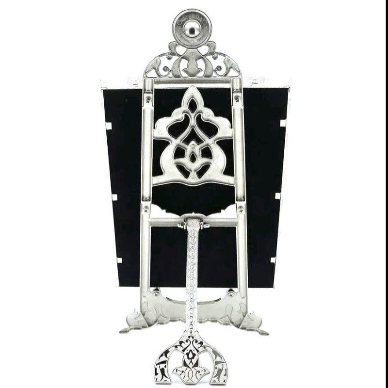 Ornate silver metal Quran holder with an elegant design.