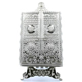 Ornate silver metal Quran holder with an elegant design.