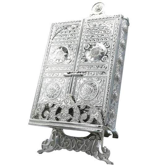 Ornate silver metal Quran holder with an elegant design.