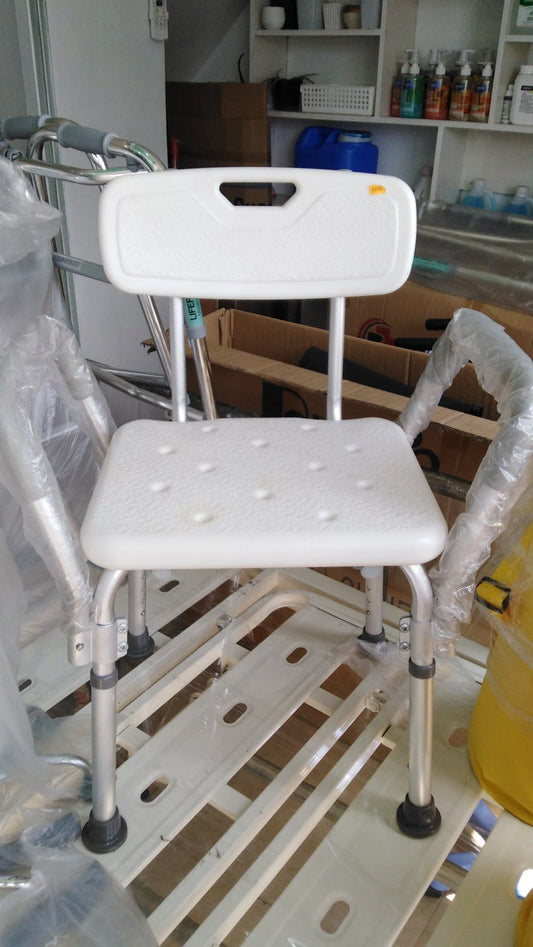 Adjustable bath chair with supportive backrest and non-slip seat surface, designed for accessibility and safety in bathroom environments