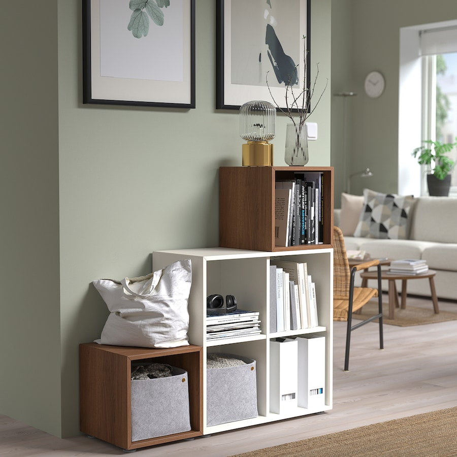 A compact white cabinet with four spacious compartments, measuring 27 1/2x13 3/4x27 1/2 inches. Ideal for organizing books, decor, or household items, its sleek, modern design suits any room, offering both style and practicality.