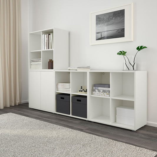 A compact white cabinet with four spacious compartments, measuring 27 1/2x13 3/4x27 1/2 inches. Ideal for organizing books, decor, or household items, its sleek, modern design suits any room, offering both style and practicality.