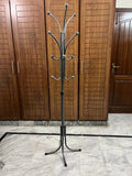 Height-adjustable steel coat hanger stand with rust-resistant silver chrome finish.