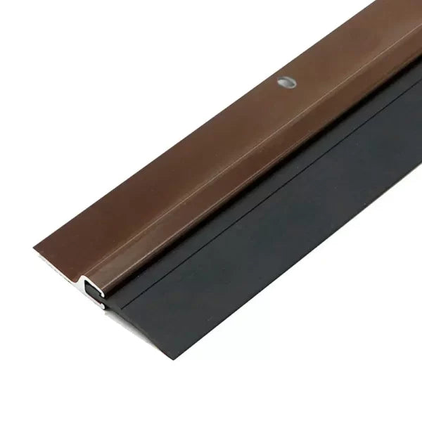 Brown aluminum door bottom seal with black rubber for soundproofing and weatherproofing.