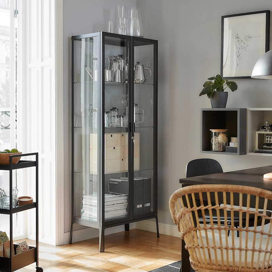 A stylish anthracite glass-door cabinet measuring 28 3/4x68 7/8 inches. Features adjustable glass shelves for customizable storage, a secure lock for safety, and a cable outlet for integrated lighting, making it perfect for showcasing glassware and collectibles while enhancing any room's decor.