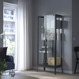 A stylish anthracite glass-door cabinet measuring 28 3/4x68 7/8 inches. Features adjustable glass shelves for customizable storage, a secure lock for safety, and a cable outlet for integrated lighting, making it perfect for showcasing glassware and collectibles while enhancing any room's decor.