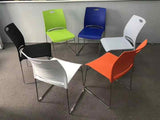 Modern stackable plastic chair available in four colors, perfect for office, training rooms, and dining spaces.