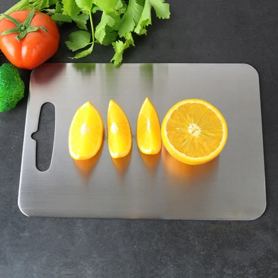 Stainless steel chopping board (33cm x 22cm), made from 100% food-grade, eco-friendly material. Features rounded edges and anti-skid pads for safety. Durable, easy to clean, and knife-friendly, perfect for chopping vegetables, fruits, and meats. Made to order, ready in 15 days.