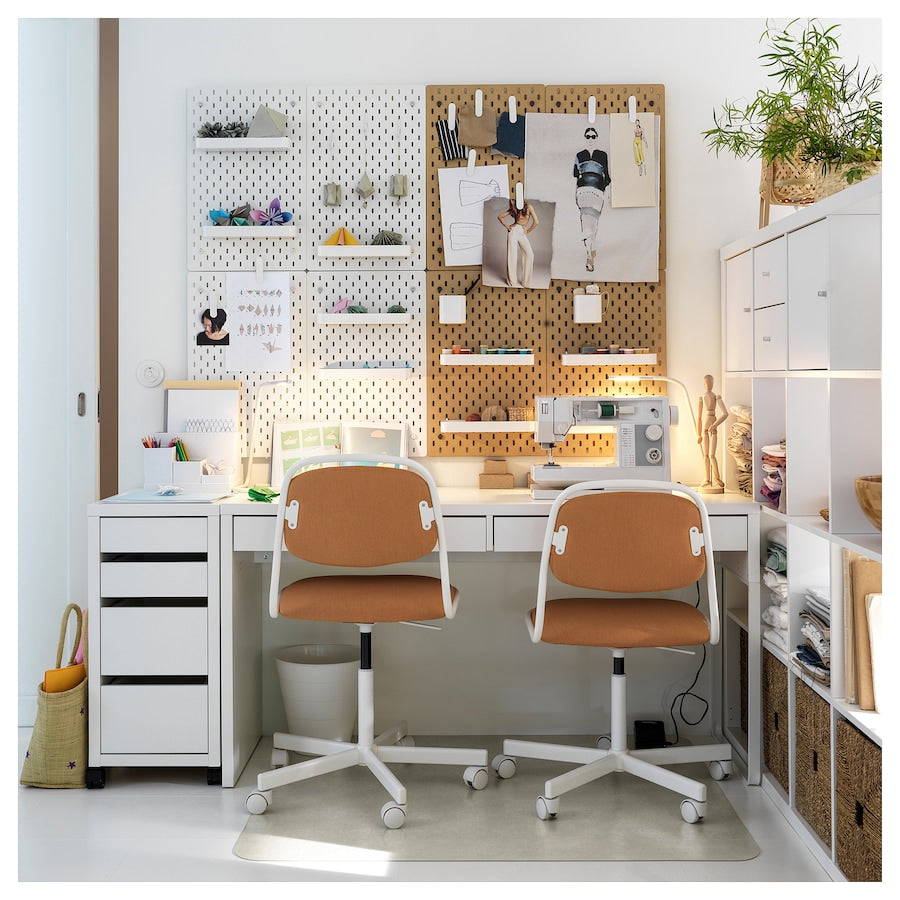 A spacious white desk measuring 55 7/8x19 5/8 inches. Features include a long tabletop suitable for two users, cable outlets for organized cord management, adjustable legs for versatile placement, and drawer stops for added safety. The finished back allows for placement anywhere in the room.