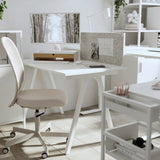 TROTTEN white desk measuring 120x70 cm with sleek A-shaped legs, designed to fit in small spaces and maximize under-desk storage for a chair and other items.