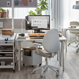 TROTTEN white desk measuring 120x70 cm with sleek A-shaped legs, designed to fit in small spaces and maximize under-desk storage for a chair and other items.