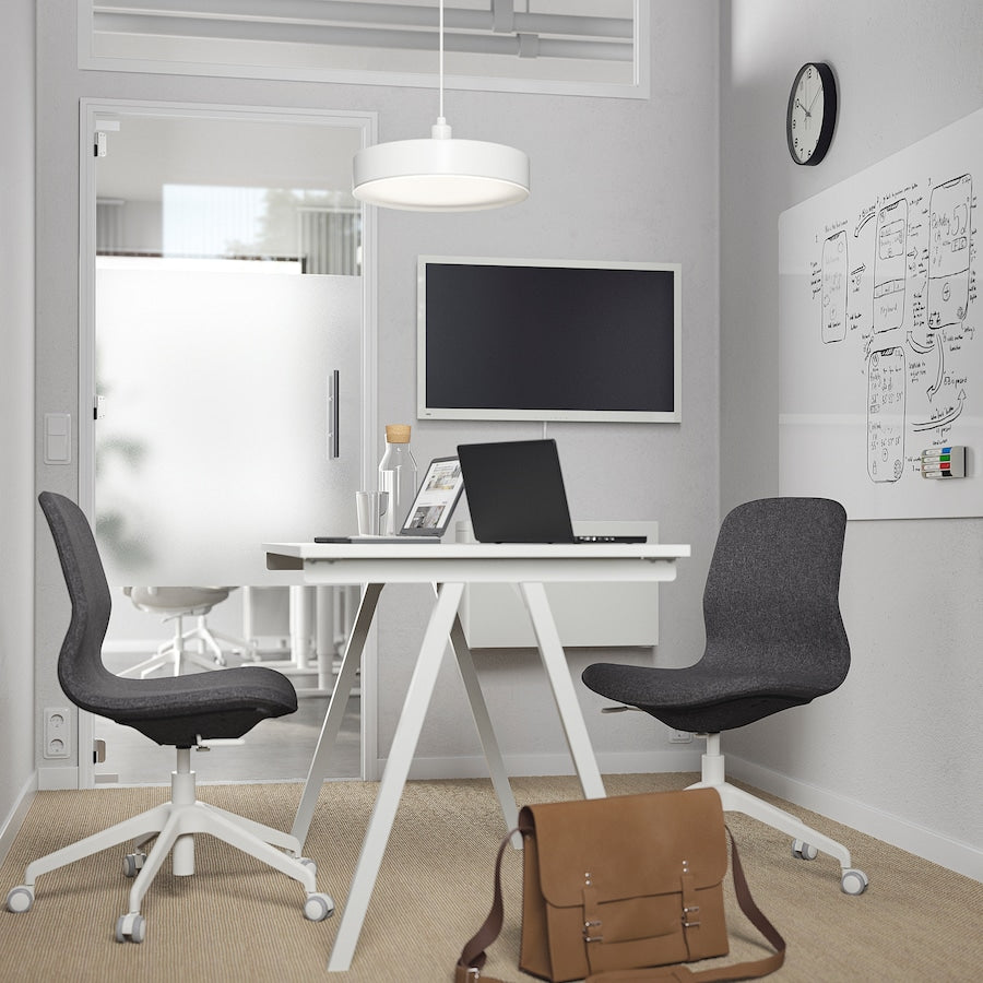 TROTTEN white desk measuring 120x70 cm with sleek A-shaped legs, designed to fit in small spaces and maximize under-desk storage for a chair and other items.