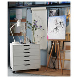 A white drawer unit on casters, measuring 26 3/8x26 inches, featuring multiple drawers for organized storage. Ideal for home offices or craft spaces, it combines mobility with modern design, making it easy to keep essentials accessible and your space clutter-free.